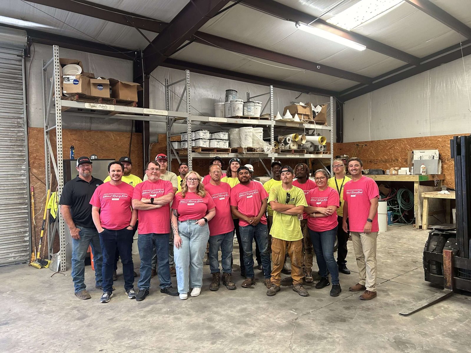 The RPI Roofing crew gathered in the shop during National Roofing Week