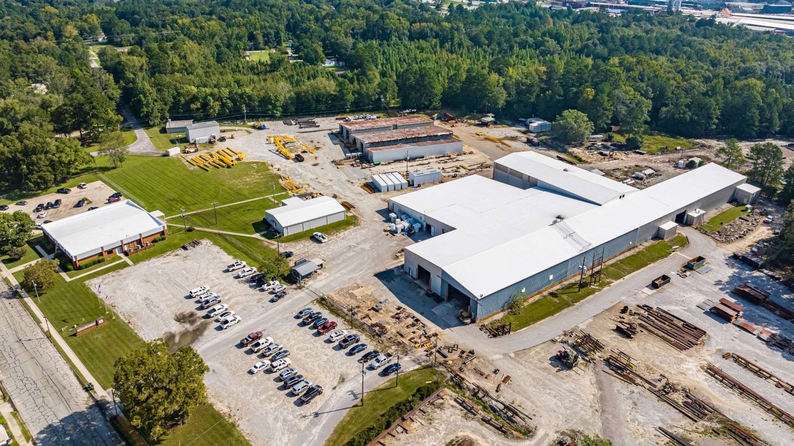 Aerial of an occupied industrial facility with a maintained white membrane roof by RPI Roofing